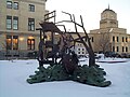 A statue in remembrance of the flood, with the rebuilt Grand Forks Herald building in the background.