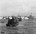 Universal carriers of 50th Division wade ashore from landing craft on Gold Beach, 6 June 1944.