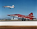 Takeoff of Northrop F-20 (S/N 82-0062, the first F-20 built) in Northrop colors with a T-38 chase plane.