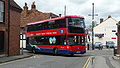 English: Wilts & Dorset 1122 (HF58 GZB), a Scania OmniCity, turning from Salt Lane into Rollestone Street, Salisbury, Wiltshire, on route X3.