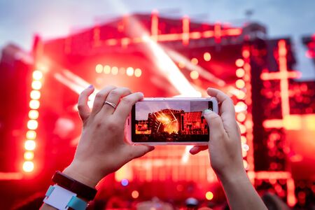 Hands with a smartphone records live music festival live concert live concert