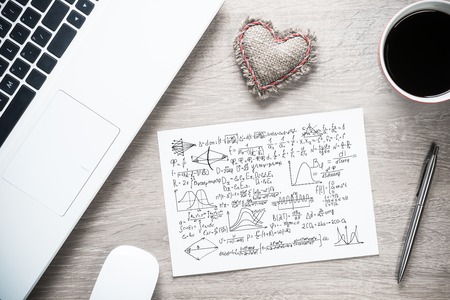 Keyboard notepad and coffee cup on wooden desk Stock Photo