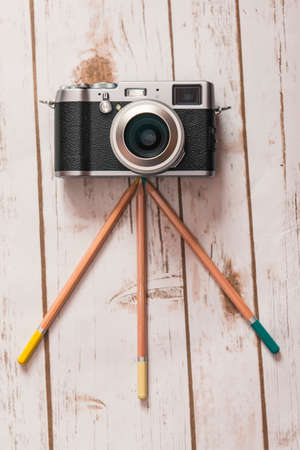 Creative photography concept vintage camera on a pencil tripod Stock Photo