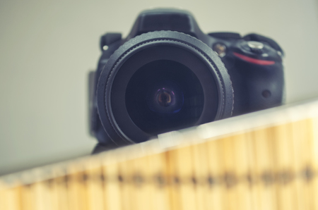 Slr camera in the reflection on a bamboo napkin