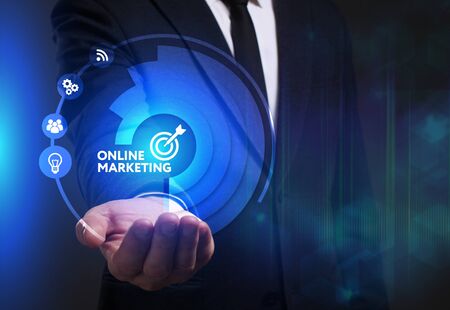 Business technology internet and network concept young businessman working on a virtual screen of the future and sees the inscription online marketing