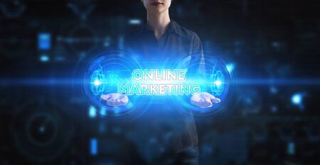 Business technology internet and network concept young businessman working on a virtual screen of the future and sees the inscription online marketing