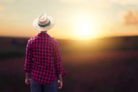 Farmer at sunset outdoor man with hat in a sunset blurry background space for text Stock Photo