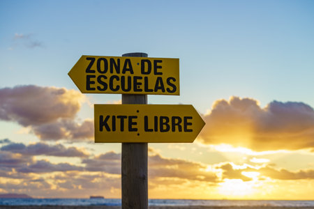 Sign in spanish at sunset beach navigate lesson and kitesurfing sports activities