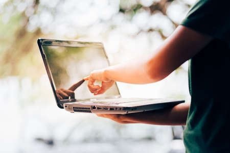 A woman pointing finger to the screen laptop Stock Photo