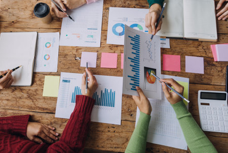 Financial analysts analyze business financial reports on a digital tablet planning investment project during a discussion at a meeting of corporate showing the results of their successful teamwork Stock Photo