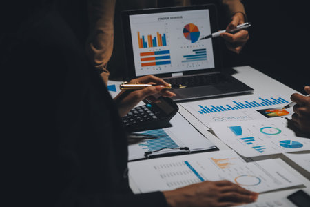 Financial analysts analyze business financial reports on a digital tablet planning investment project during a discussion at a meeting of corporate showing the results of their successful teamwork