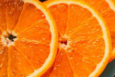 Fresh sliced orange slices close up on plate