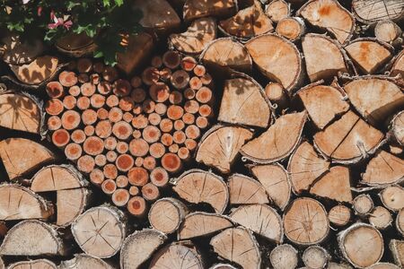 Wooden stack logs arranged and heart shape in a wall