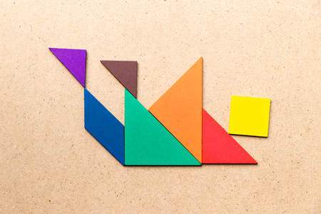 Color tangram puzzle in falling man shape on wood background concept for business crisis Stock Photo