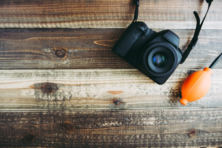 Digital camera on wooden table Stock Photo