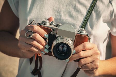 Woman holding retro vintage camera outdoors old camera beautiful female photography