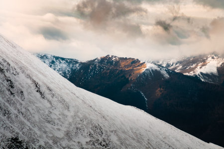 Dramatic weather in mountains during winter Фото со стока