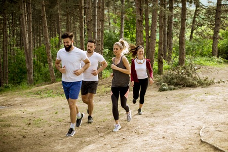 Young people run a marathon through the forest