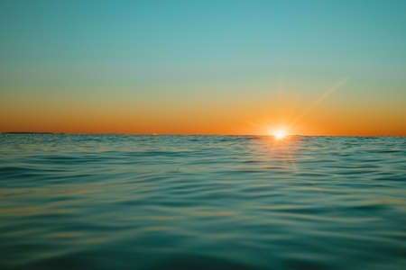 Sol saliendo sobre el agua en Mollymook Beach. Foto de archivo