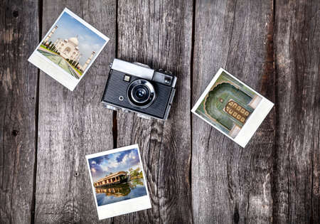 Old film camera and photos with indian famous landmarks on the wooden background