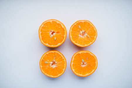 Sliced orange fruit segments isolated on white background