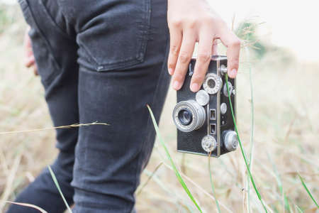 Woman photographed in a meadow with a camera Stock Photo