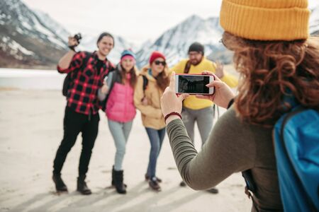 Group of happy friends hikers are taking photo together in mountains area Stock Photo