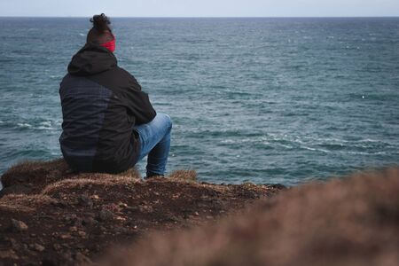 Man sitting by the sea may 2018 Stock Photo