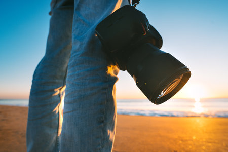 Photographer with his camera on the beach sunset photography Stock Photo