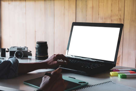 Designer in purple shirt graphic creative holding taplet computer and working on laptop in small office selective focus Stock Photo