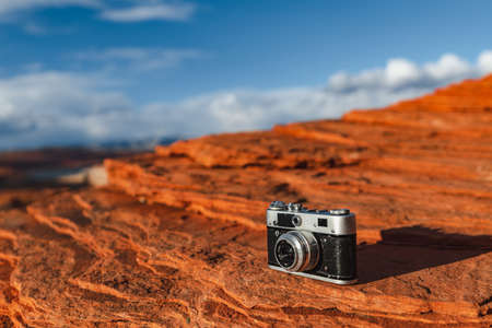 Retro camera on the stone at the canyon