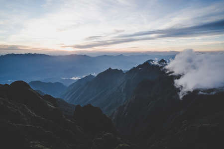 Sunset in the mountains gloomy evening view from the high fansipan mountain to the clouds in the evening sunset in vietnam valley