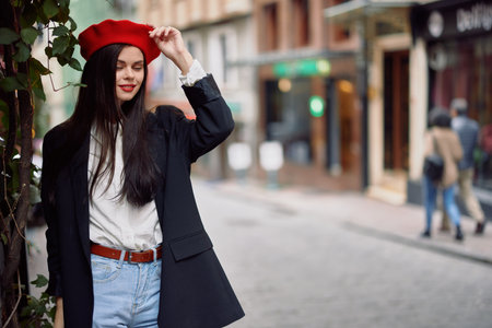 Girl smile with teeth stands on the street in the city in a jacket and red beret cinematic french fashion style clothing travel to istanbul
