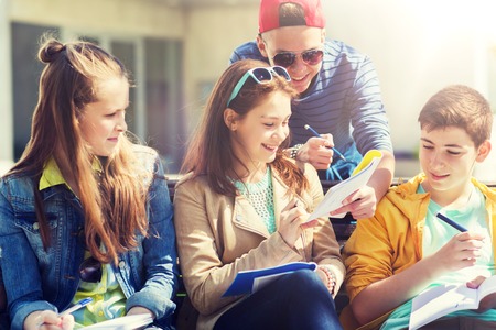 Group of students with notebooks at school yard