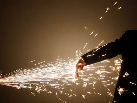 A person s hand and fireworks Stock Photo