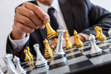 Businessman leadership playing chess and thinking strategy plan about crash overthrow the opposite team and development analyze for successful of corporate