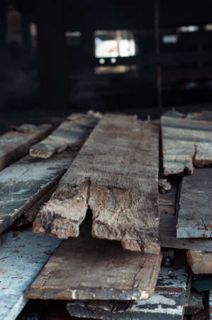 A pile of wooden planks from old houses stacked for burning