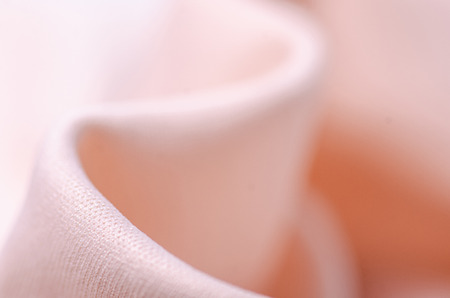 Peach pink fabric textile material texture macro blur background Stock Photo