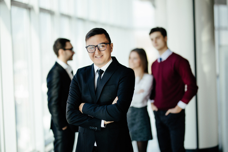 Portrait of an handsome businessman in front of his team