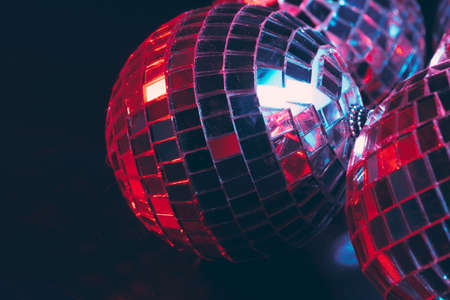 Group of shiny disco balls on dark background close up