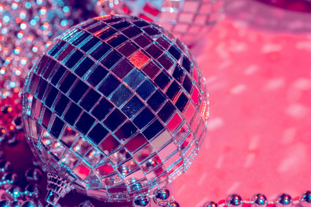 Mirror disco balls over pink background party nightlife concept