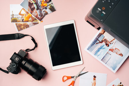 Printer photo camera and digital tablet on table printing photos concept