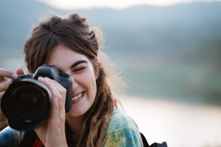 Woman hiker alone enjoy the beauty of nature with camera