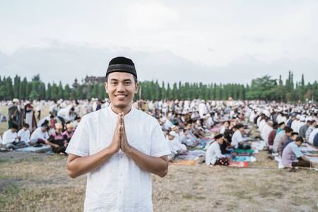 Close up of asian young man smile by gesture apologize