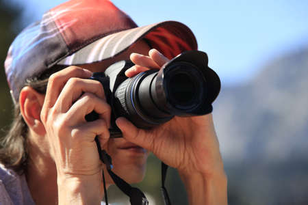 Man with photo camera taking pictures Stock Photo