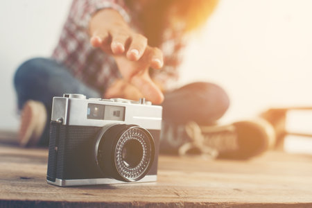 Young hipster woman hand reach out for catch retro camera Stock Photo