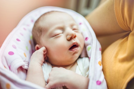 Cute sleeping baby on the bed indoors