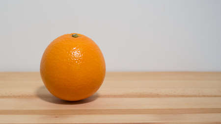 Fresh ripe orange on wooden surface side view space to right