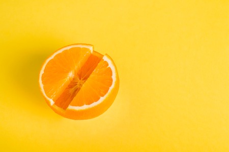 Concept vitamin s fresh orange in pill form yellow background metaphor minimalism close up