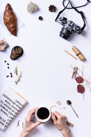 Coffee break breakfast with espresso and croissant hands holding a cup travel concept top view copy space